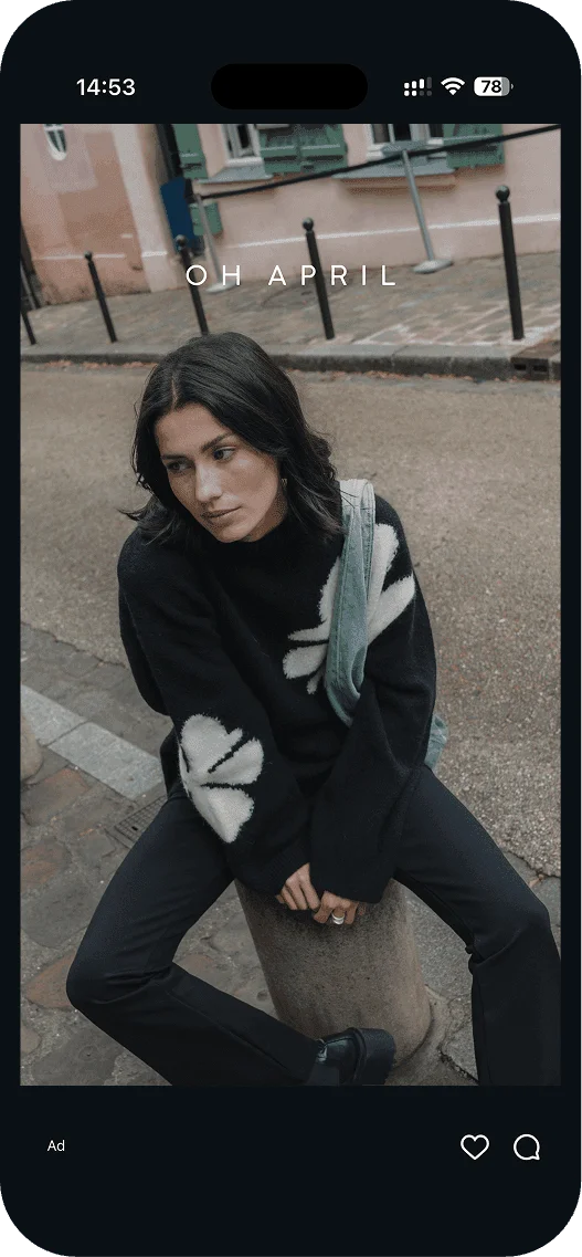 Oh April ad: model in a black sweater on a city street