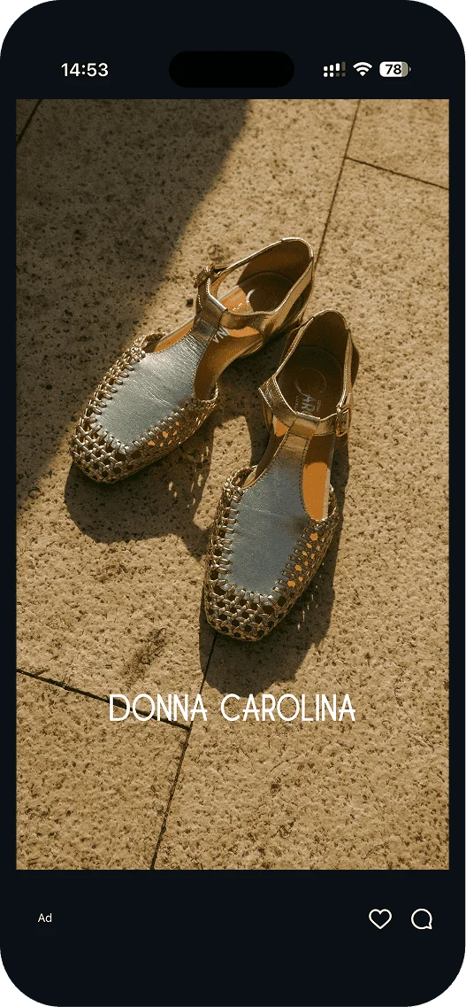 Golden Donna Carolina sandals on stone walkway.