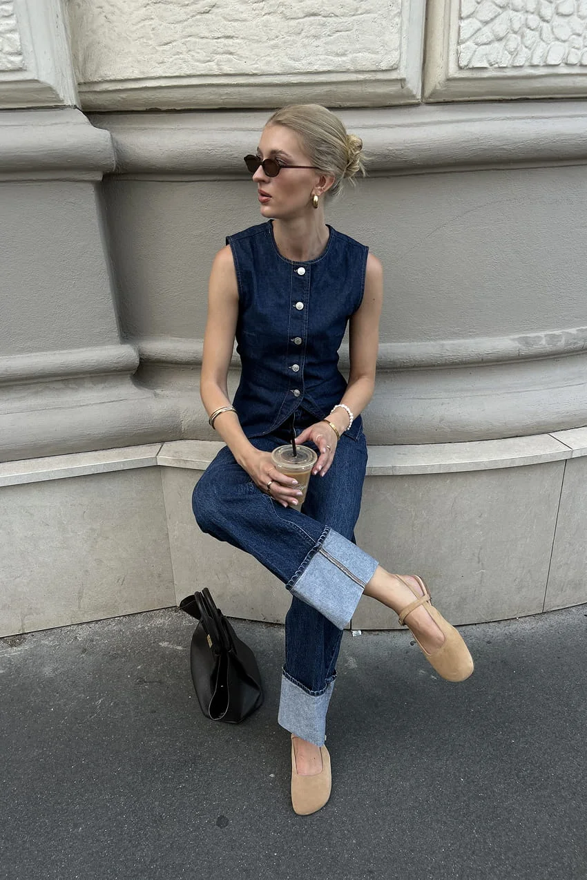 Denim vest and jeans outfit with coffee.