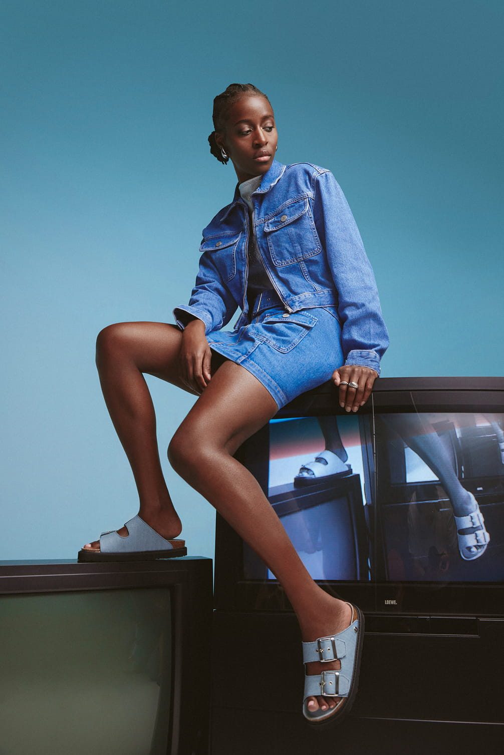 Woman in denim jacket and skirt with sandals